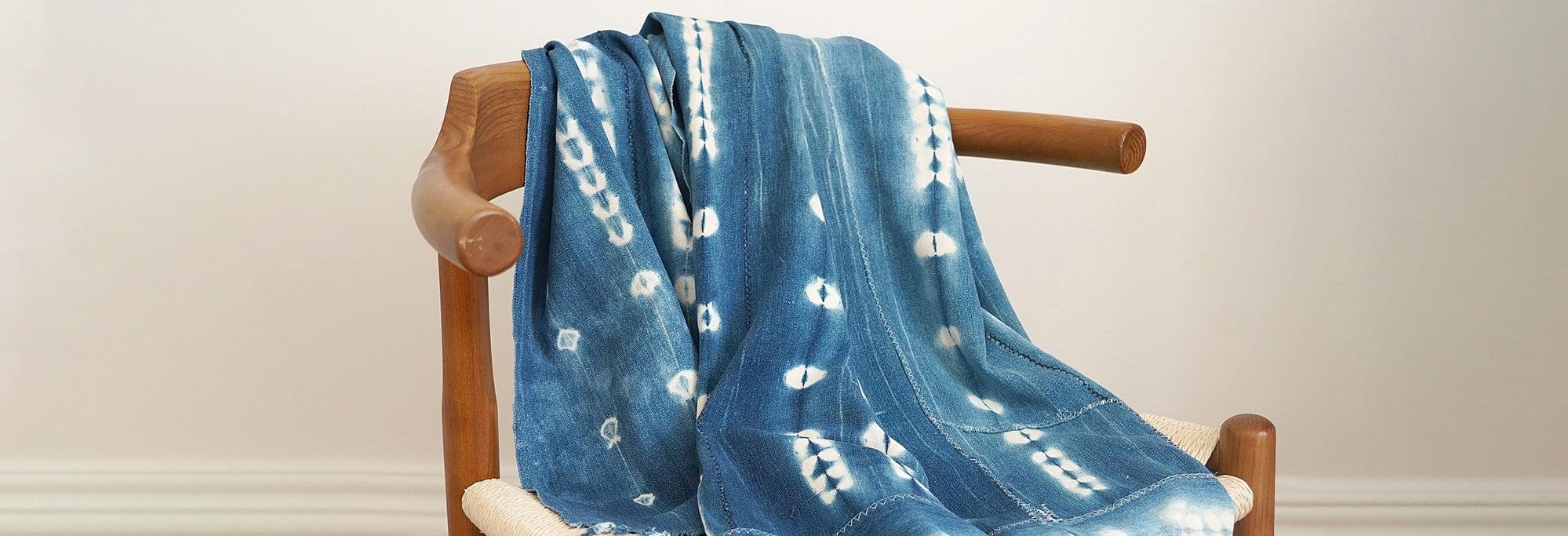 The BOGOLAN CLOTH THROWS Collection - Wooden chair featuring the Handmade Bogolan Cotton Throw I